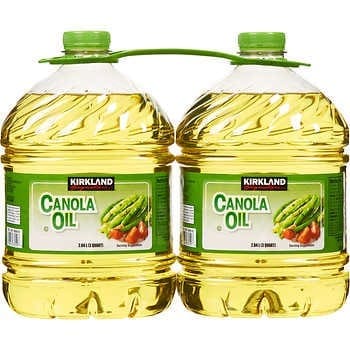 A couple of large bottles of oil with green handles.