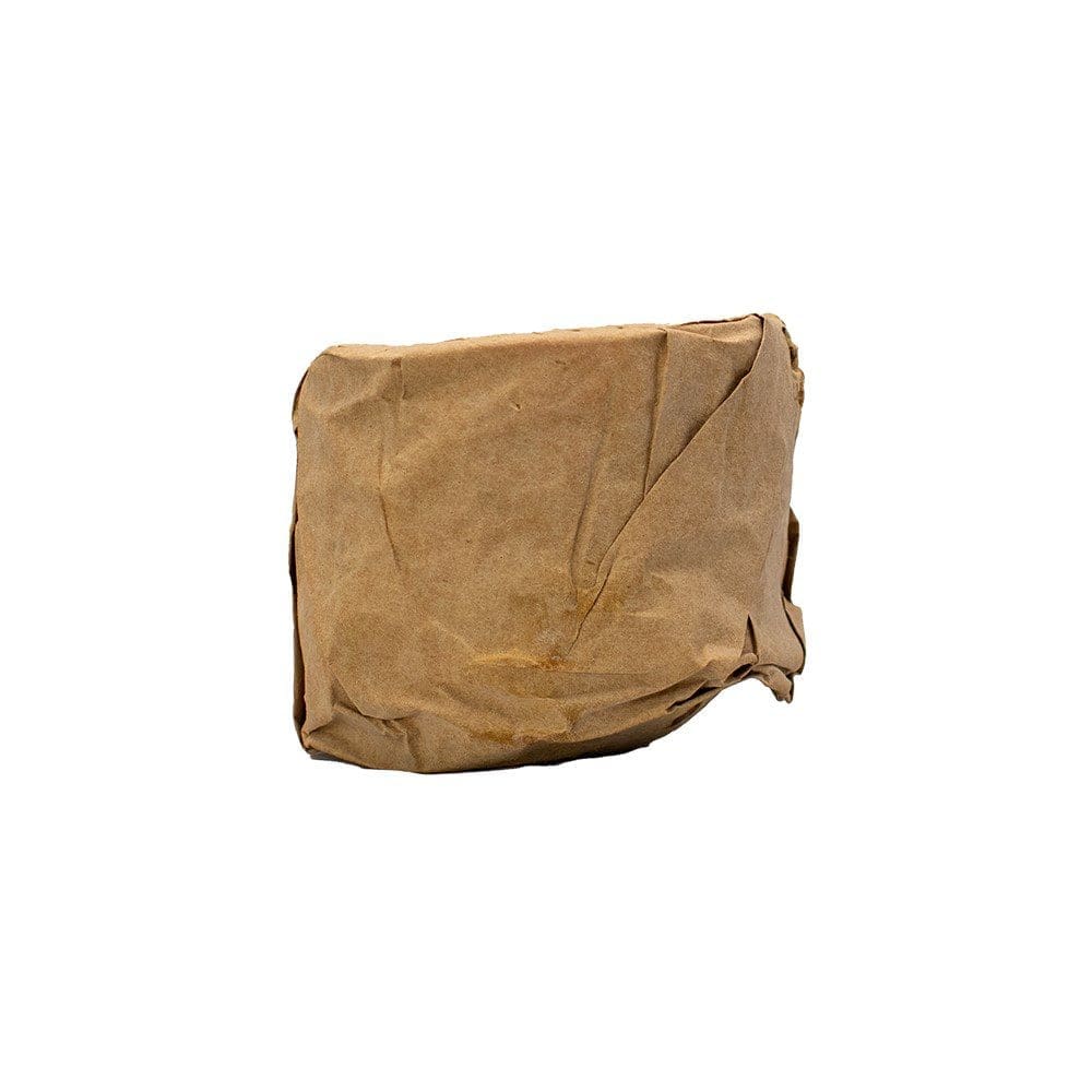 A brown paper bag sitting on top of the ground.